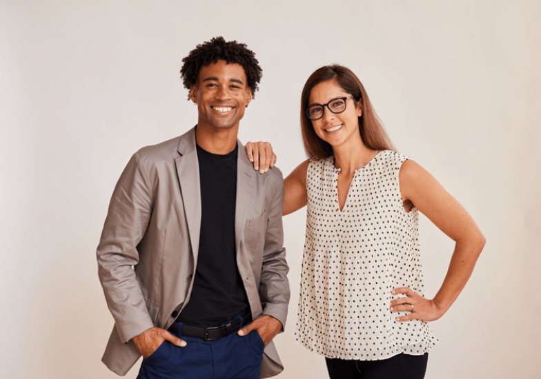 Med spa owners standing together in their clinic, smiling